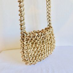 High end designer quality manufactured purse made of 2 kinds of thick gold interlocked chain. Rectangular shape and lined in gold metallic vinyl. Closure at the top consists of a small chain that connects to a metal hook. Shoulder strap is composed of 2 gold chains connected with the gold rings. **Ask me about International shipping rates. Label:  None.  I bought the purse from a woman who said she purchased it from a high end store in LA in 1969. Condition:  Excellent.  Looks barely used.  Inte Yellow Gold Rectangular Shoulder Bag With Gold-tone Hardware, Formal Gold Metal Shoulder Bag, Metallic Rectangular Shoulder Bag With Chain Strap, Rectangular Metal Shoulder Bag With Chain Strap, Yellow Gold Rectangular Shoulder Bag, Metallic Rectangular Bag With Chain Strap, Gold Chain Clutch Shoulder Bag, Chic Gold Metal Evening Bag, Metal Rectangular Evening Bag With Chain Strap