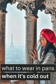 a woman wearing a red hat standing on top of a building with the words what to wear in paris when it's cold out