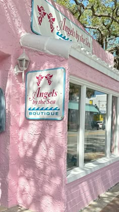 a pink building with an angel's by the sea sign on it