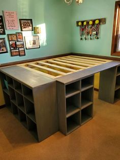 a bed frame made out of plywood and some shelves