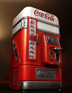 a red and white coca cola machine sitting on top of a table