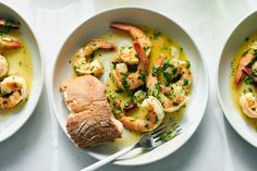 three white bowls filled with shrimp and grits