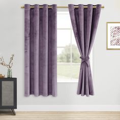 a living room with purple curtains and a window