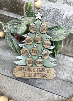 a wooden christmas tree ornament with personalized tags on it sitting on a table