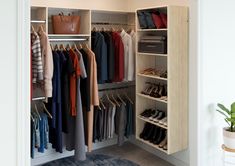 an open closet with clothes and shoes on hangers