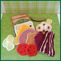 several crocheted items are laid out on a green tablecloth with plaid background