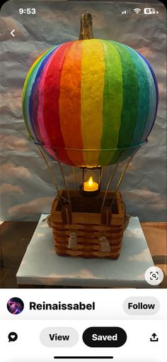 a hot air balloon with the colors of rainbow on it