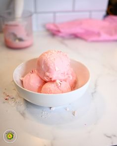 a white bowl filled with ice cream on top of a counter