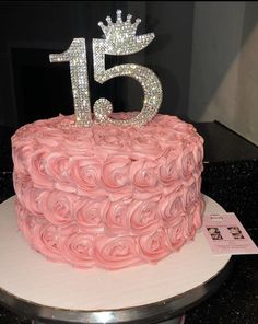 a pink cake decorated with roses and a tiara on top that says 13th birthday