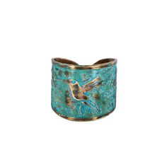 a gold and turquoise ring with a bird on it