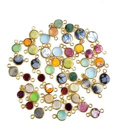 a bunch of different colored stones on a white background