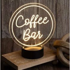 a coffee bar sign with the words coffee on it and a light up lamp that says coffee