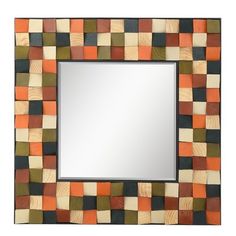 an orange and black square mirror on a white wall with wood squares in the background