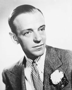 black and white photograph of a man wearing a suit with a flower in his lapel