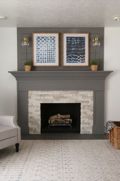 a living room with a fire place and two pictures on the fireplace mantels