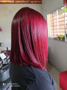 a woman with red hair is looking out the window