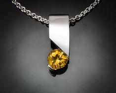 "Citrine Necklace - Argentium Silver - 3460 - Argentium Chain Included A delicate pendant design with clean, contemporary lines. ( IMPORTANT - PLEASE READ 1. AND 2 BELOW ) 1.) INCLUDED IN THE PRICE IS AN ARGENTIUM SILVER CHAIN APPROPRIATE FOR THE PENDANT CHOSEN. YOU CAN CHOOSE FROM 16\", 18\" OR 20\" LENGTH AT CHECKOUT. 2.) PLEASE LOOK AT THE MEASUREMENTS CAREFULLY. SOME PHOTOS HAVE BEEN ENLARGED TO SHOW DETAIL, WHILE OTHERS HAVE BEEN MINIMIZED TO FIT THE FRAME. ACTUAL SIZE CANNOT BE DETERMINED Modern Silver Jewelry With Birthstone, Contemporary Sterling Silver Necklace With Polished Finish, Modern White Gold Jewelry With Birthstone, Modern Polished Finish Necklaces For Anniversary, Modern Gemstone Necklace For Anniversary, Modern Silver Jewelry With Tension Setting, Modern Jewelry With Large Pendant For Anniversary, Modern Silver Birthstone Necklaces, Modern Silver Birthstone Necklace