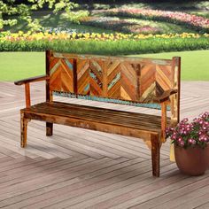 a wooden bench sitting on top of a hard wood floor next to a potted plant