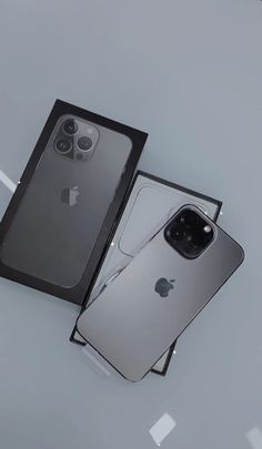 an iphone 11 is in its box next to it's new packaging, which has been placed on the table