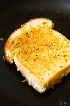 a grilled cheese sandwich is being cooked in a skillet with some seasoning on top