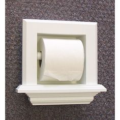 a toilet paper dispenser mounted on the wall with a roll of toilet paper