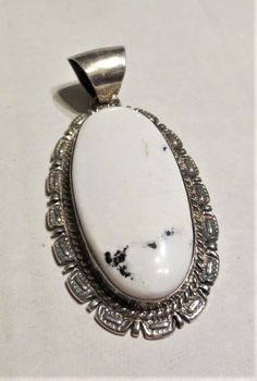 This is a lovely white agate and sterling silver pendant. Made by Navajo designer Althea Latome. circa 1980 +/- 7cm x 3.2cm Bale is roughly 1cm inner diameter. about 20.8g total weight. A welcome addition to your collection. Please feel free to ask questions or make offers. Thanks!! Elegant Untreated White Jewelry, White Oval Pendant With Polished Finish, Southwestern Oval Natural Stones Jewelry, Southwestern Style Jewelry With Oval Natural Stones, Southwestern Style Oval Natural Stone Jewelry, White Agate Round Pendant Jewelry, Classic White Oval Pendant Jewelry, Unique White Jewelry With Polished Finish, Untreated Southwestern Oval Jewelry