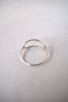 This item is made to order and will ship after 7-10 business days. That time does not include holidays, weekends or shipping time! I twist a length of Sterling Silver metal into an elongated oval shape and lightly hammer it. The hammered effect adds lots of shine and sparkle, so even through the metal itself is very light and feminine, the ring has a big impact overall. I then connect a Sterling Silver band around the back for a perfectly customized fit. This ring is incredibly easy to wear and Minimalist Hand Forged Open Midi Rings, Everyday Hammered Open Midi Rings, Elegant Sterling Silver Midi Rings, Elegant Silver Circle Midi Rings, Elegant Open Circle Midi Rings, Elegant Everyday Midi Rings, Minimalist Adjustable Rings, Minimalist Infinity Stackable Rings For Everyday, Minimalist Hammered Ring With Open Band