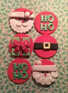 four decorated cookies with santa claus and other decorations