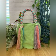 Description: Cute Pastel Green Top Handle Wayuu Bag These Boho Bag Was 100% Hand Knit By Wayuu Women But Designed By Us. The Wayuu Are An Indigenous Tribe In Colombia Known For Their Beautiful Handwoven Work, And This Bag Represents About A Week's Worth Of Work. Details: Handmade Item - Handwoven Color: Pastel Lime Green, Pink, Blue & Purple Material: 100% Acrylic Width: 11" Height: 11" Total Length: 20" Materials: Nylon, Cotton Style: Boho Chic / Classic/ Stylish/ Elegant Casual Handmade Pink Bucket Bag, Trendy Green Handwoven Shoulder Bag, Handmade Pink Crochet Bag With Double Handle, Green Crochet Bucket Bag With Braided Handles, Trendy Pastel Bag For Daily Use, Green Handmade Satchel Bucket Bag, Handmade Green Satchel Bucket Bag, Trendy Handmade Green Bags, Trendy Green Handmade Bag