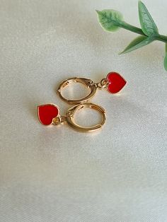 ❤Gorgeous little pair of handmade heart 18K Gold plated huggie hoop earrings. ❤The little red enamel heart is just 8mmx7mm       and the long lasting 18K Gold plated huggies are a cute 12mm in diameter.   ❤Hypoallergenic and great for sensitive ears.  ❤ Perfect huggies for everyday wear or a gift for that someone special. They will arrive in a lovely velvet pouch ready for gifting 🎁  Note colours may vary due to individual monitors but please contact me with any queries.  Thanks for checking ou Affordable Huggie Heart Earrings As A Gift, Trendy Huggie Hoop Earrings With Heart Charm, Trendy Huggie Heart Earrings For Valentine's Day, Single Huggie Earring For Valentine's Day, Valentine's Day Huggie Single Earring, Valentine's Day Single Huggie Earring, Trendy Small Hoop Earrings For Valentine's Day, Trendy Small Hoop Jewelry For Valentine's Day, Trendy Huggie Earrings For Valentine's Day