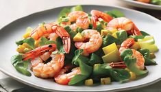 a white plate topped with shrimp and veggies