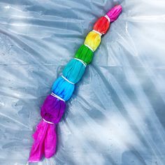 a rainbow colored umbrella laying on top of plastic