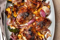 a plate filled with meat and vegetables on top of a table next to a fork