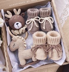 a box filled with crocheted baby booties and stuffed animals