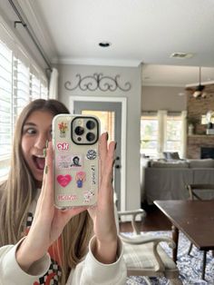 a woman taking a selfie with her cell phone in front of the camera,