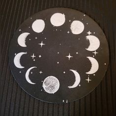 the moon and stars are drawn in chalk on a black surface with pinstripe