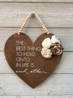 the best thing to hold onto in life is each other wooden heart sign with beaded cord