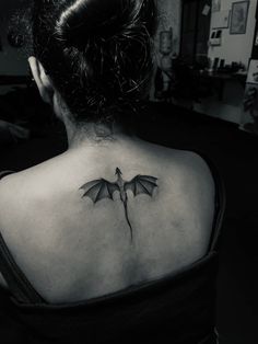 a woman with a dragon tattoo on her back