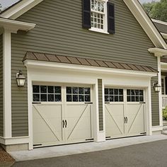 a house with two garage doors and windows