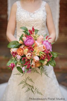 a bride holding a bouquet of flowers in her hands