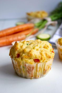 a close up of a muffin with carrots and celery in the background