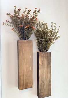 two wooden vases with plants in them