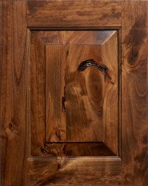 a close up of a wooden door with a bird on it's face in the center