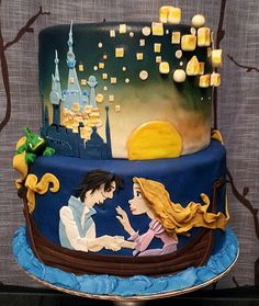 a three tiered cake decorated with disney princess and prince silhouettes