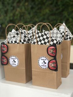 brown paper bags with black and white checkers on them are sitting on a table