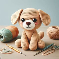 a crocheted dog sitting on top of a table next to balls of yarn