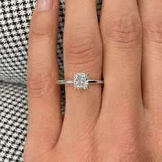 a woman's hand with a diamond ring on it