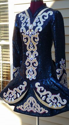 a woman's blue and white sequin dress on display