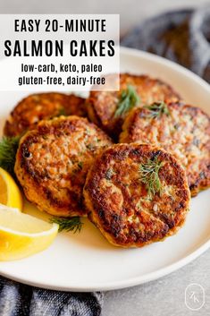 salmon cakes on a plate with lemon wedges