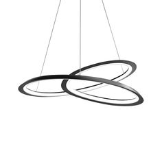 two circular lights suspended over a white surface with black rings on the bottom and one light hanging from the ceiling